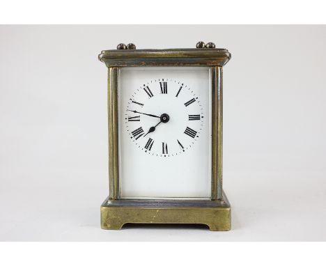 A brass and bevelled glass cased carriage clock with Roman numerals, 14cm high