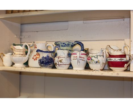 A collection of twelve Victorian and later porcelain and pottery milk jugs, various makers including Doulton, Royal Worcester