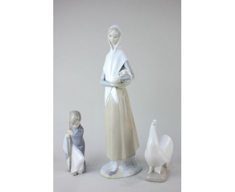 A Nao porcelain figure of a woman with basket of apples, 35cm high, a Lladro figure of a kneeling boy, and a Nao model of a d