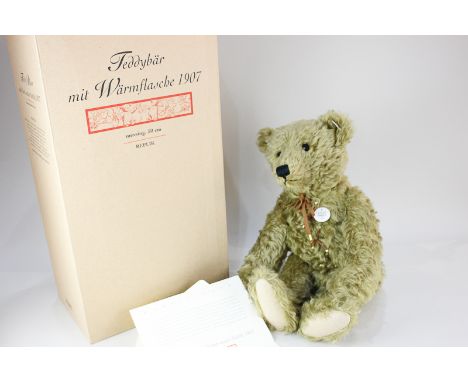 A Steiff brass coloured mohair replica 1907 teddy bear with hot water bottle, limited edition 2030/3000, with original certif