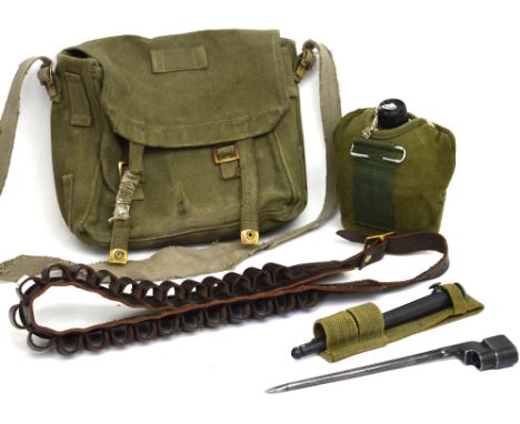 A canvas rucksack, an ammunition belt, a WWII British spike bayonet fitting No.4 MkII, a military water bottle, a WWII ration
