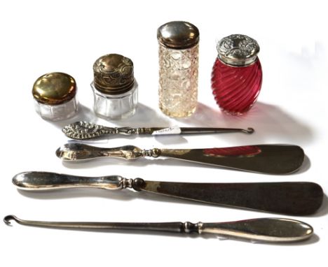 An Edward VII hallmarked silver topped cranberry glass trinket pot, three other cut glass trinket pots, two with hallmarked s