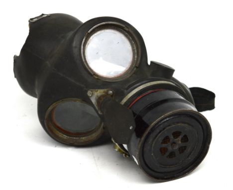 A WWII rubber-faced gas mask, Model SHCR 11/39, with elasticated straps and canister.