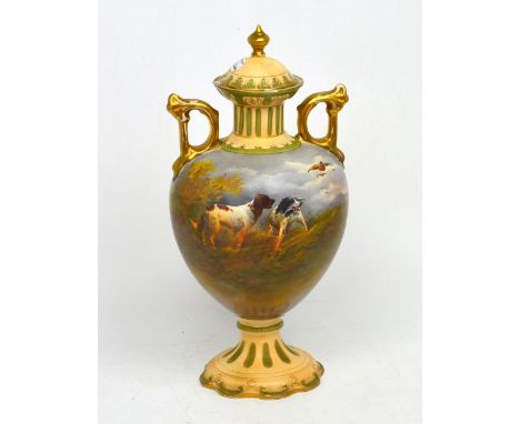 A Crown Devon twin-handled covered urn, signed 'R. Hinton', decorated with gun dogs in moorland scene with grouse, marked '09