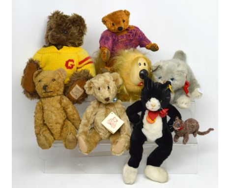 A collection of soft toys to include an early 20th century straw-filled teddy bear, with moveable joints and brown glass eyes