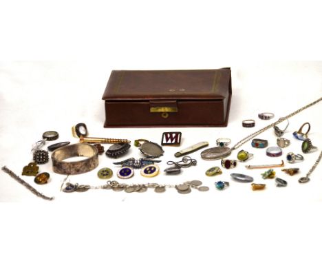 A quantity of silver and other costume jewellery to include an engraved snap bangle, a hallmarked silver locket, a silver squ