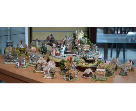 A quantity of 'Lilliput Lane' figures to include a large model of a seaside village and twenty-two smaller cottages (23).