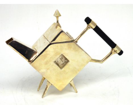 In the style of Christopher Dresser; a white metal teapot, marked to base 'Designed by Dr C Dresser' with registration mark, 
