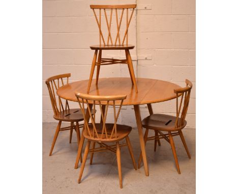 A 1960s Ercol light elm oval drop-leaf dining table, length when extended 123cm and a set of four cross stick back chairs (5)