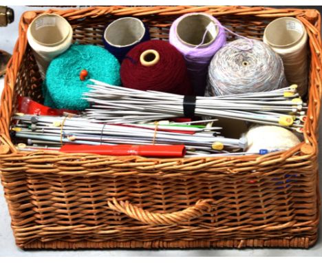 A vintage picnic hamper containing a large quantity of vintage knitting needles, crochet hooks, woollen yarn etc.