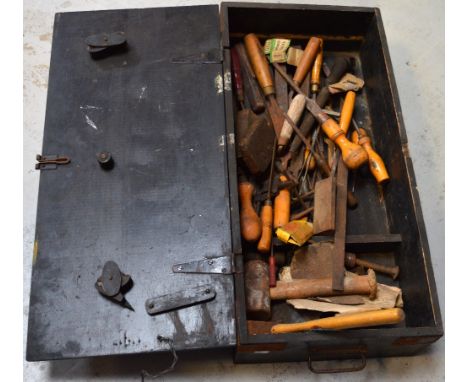A vintage toolbox containing a quantity of vintage tools to include mallet, hammers, screwdrivers, chisels etc.
