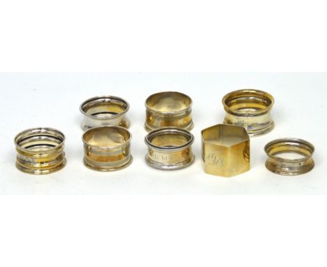 Eight hallmarked silver napkin rings to include a George V hexagonal plain example with 'DS' monogram to front, Duncan & Scob