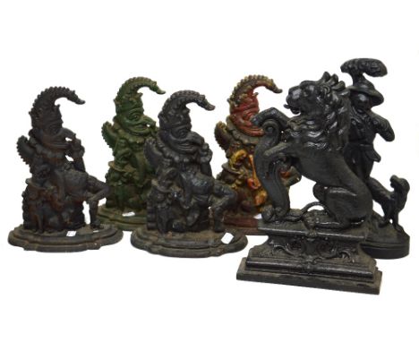 Four early 20th century 'Punch' doorstops, a doorstop of a man hunting with a dog and a rearing lion, height of largest 39cm.
