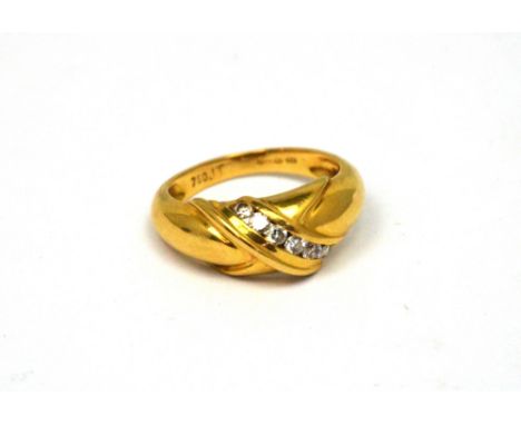 An 18ct yellow gold ring set with seven diamonds in an 'X' shaped design, size M, approx 5.1g.