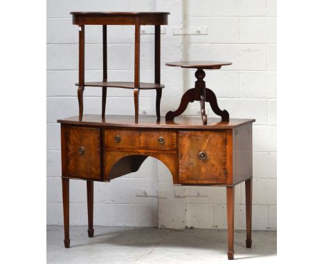 A reproduction mahogany cross-banded bow-front sideboard, central drawer flanked by two cupboard doors on tapering legs, leng