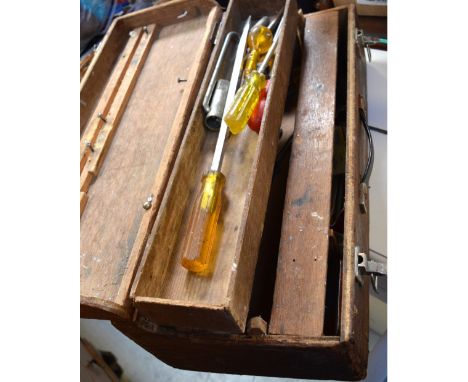 A vintage toolbox containing screwdrivers, hammers etc.