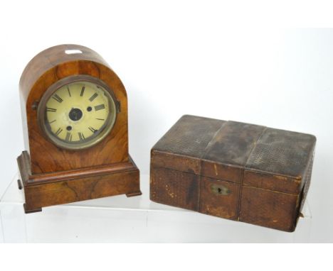 A c1930s walnut dome-top clock case, enamel dial set with Roman numerals, lacking movement and an early 20th century basket-s