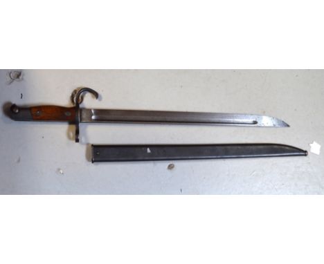 A WWII Japanese Arisaka bayonet with metal scabbard.   CONDITION REPORT  Some bruising to wooden handle/hilt, pitting in seve