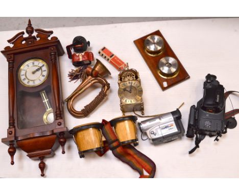 A collectors' lot to include a vintage money box, ornamental bongo drums, an Elega mouth organ, a military-style bugle, moder