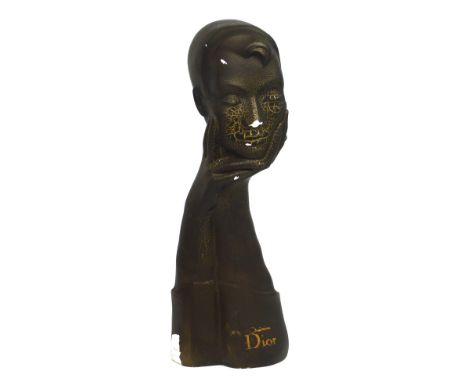 An original Christian Dior plaster black and gilded model of a lady's face, hands and part torso, inscribed to the front in g