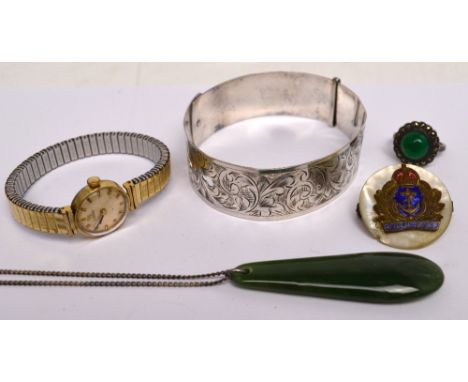 A small quantity of jewellery to include a sterling silver engraved belt bangle, a ladies' Tissot wristwatch with expandable 