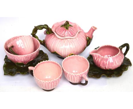 A Zsolnay Pecs pink flower-shaped tea service to include a small teapot, two cups with leaf-shaped saucers, one cup, sugar bo