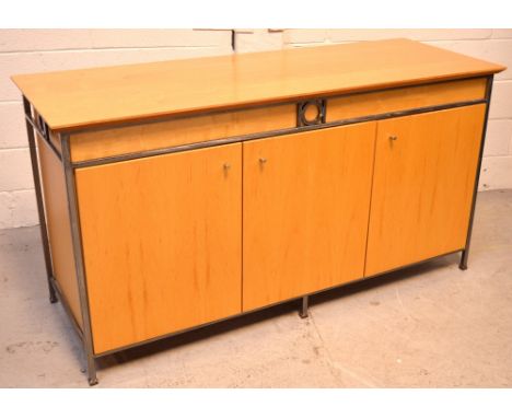 A contemporary sideboard, three cupboard doors with one interior shelf with metal trim, on slender metal supports, 160 x 83cm