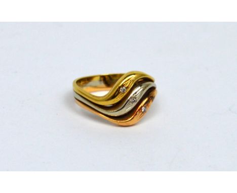 An 18ct yellow, white and rose gold band set with three small diamonds, size M, approx 5.8g.