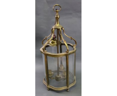 A reproduction Regency style brass frame hall lantern, of serpentine outline, 49cm high.
