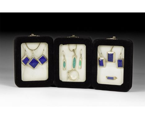 20th century AD. A group of three jewellery sets in silver-coloured metal with lapis lazuli and other stone inserts, each in 