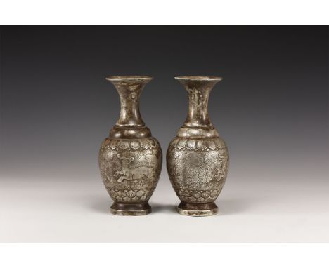 An undated archaistic pair of silver coloured metal vases with flared rims and tapering necks, bulbous collar beneath; body d