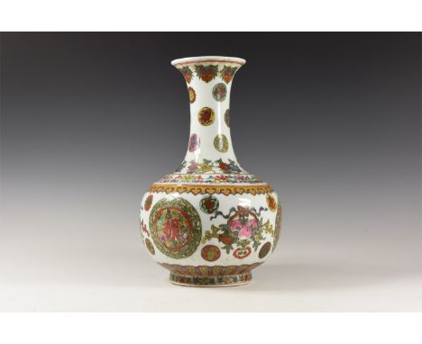 20th century AD. A glazed ceramic vase with tall waisted neck and flared base, stepped shoulder; polychrome floral ornament a