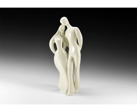 20th century AD. A hollow-formed white-glazed ceramic statuette of a couple walking with arms linked; marked to the underside