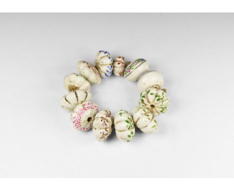 20th century AD. A restrung group of glazed ceramic beads comprising ten graduated melon beads with floral detailing, two bic