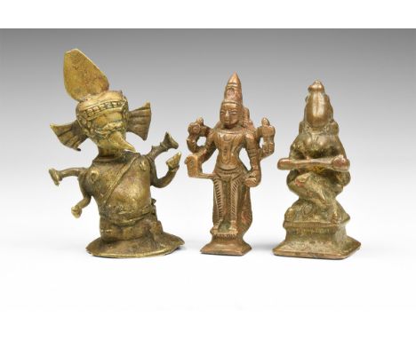 20th century AD. A mixed group of three copper-alloy statuettes comprising of: a seated goddess Annapurna holding a spoon, a 