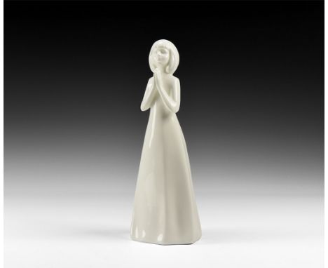 20th century AD. A hollow-formed white-glazed ceramic statuette of a girl with hands pressed together in prayer; marked to th