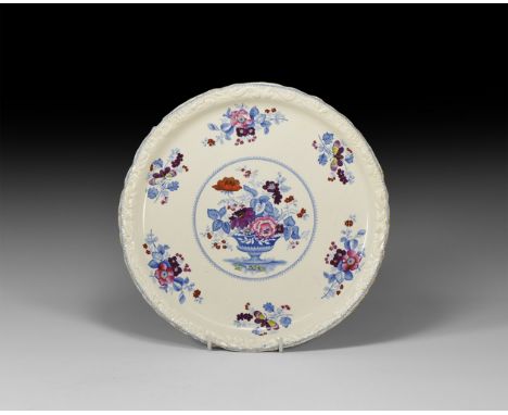 19th century AD. A white glazed ceramic tazza with moulded scroll detailing to the rim, blue and white floral motifs with add