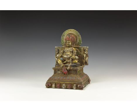 An undated archaistic bronze figure of Kubera, hair pulled up into a top knot, crown with five floral points, bands of neckla