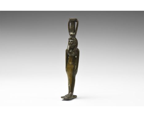 20th century AD. A bronze style Egyptian figure of a goddess wearing a close fitting dress, arms to the side; tripartite wig 