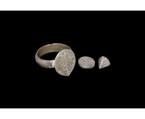 10th-14th century AD. A mixed silver group comprising: a finger ring with teardrop bezel,leaf detailing; a pyramidal finial w