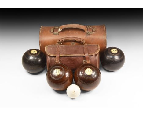 20th century AD. A pair of bowls sets, each in a leather case, comprising: one with two walnut(?) balls marked '4 5 1/8 No.3 