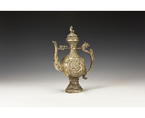 An undated archaistic silver coloured metal ritual ewer with domed lid decorated with three lions on the rim, standing lion t