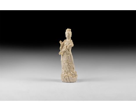 20th century AD. A hollow-formed white-glazed ceramic statuette of a courtly lady supporting a sceptre(?) on her left forearm