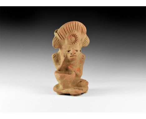 An undated archaistic ceramic figure if a male seated wearing a large fan shaped headdress open to the top to form a cup; rig