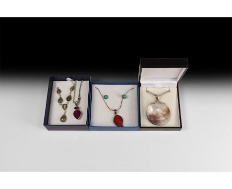20th century AD. A mixed group of jewellery items comprising: a biconvex nacre disc in silver-coloured metal setting with cha