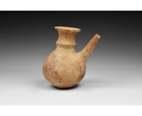 16th-17th century AD. A ceramic vessel with flared rim 'poppy head' neck and globular body; straight tapering spout to the fr