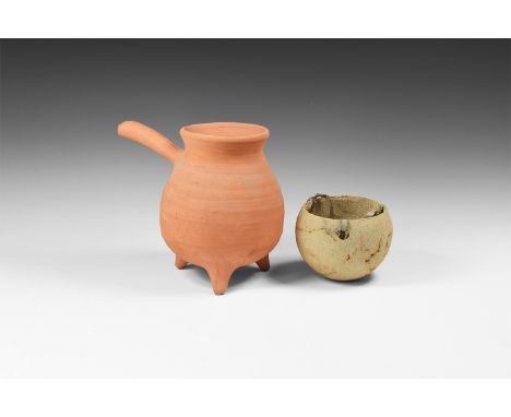 20th century AD. A mixed group comprising: a terracotta cooking vessel with three stub legs, everted rim, short shank handle;