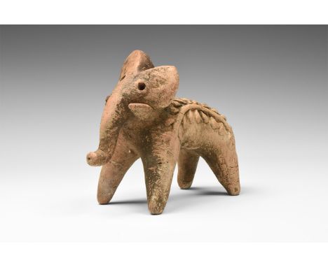 3rd-2nd millennium BC. A ceramic figure of a votive elephant with short tusk and curving trunk; body with two bands of plant 
