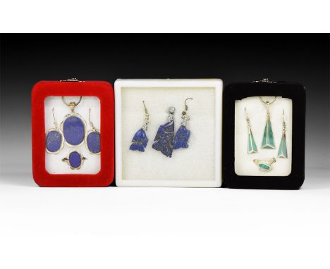 20th century AD. A group of three jewellery sets in silver-coloured metal with lapis lazuli and enamel(?) inserts, each in a 