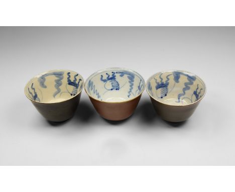 Chinese Glazed Tea Bowl Group, 20th century AD. A group of three glazed ceramic tea-bowls, each with brown exterior, blue des